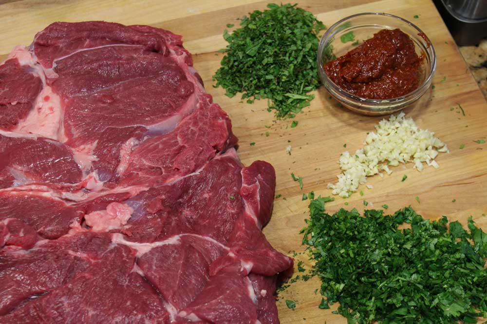 Butterflied leg of lamb, harissa paste, garlic and herbs.